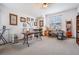 This bonus room features two craft tables, a sewing machine, shelving, and natural light at 5116 Gato Del Sol Cir, Wesley Chapel, FL 33544