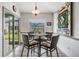 Cozy breakfast nook with wicker chairs, a glass sliding door, and view to the backyard at 5116 Gato Del Sol Cir, Wesley Chapel, FL 33544