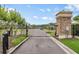Community gate with stone accents and secure entry for residents and guests at 5116 Gato Del Sol Cir, Wesley Chapel, FL 33544