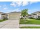 Cozy home with well-kept lawn, concrete driveway, and attached two-car garage at 5116 Gato Del Sol Cir, Wesley Chapel, FL 33544