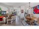 Open-concept living space with wood floors, comfortable seating, and abundant natural light at 5116 Gato Del Sol Cir, Wesley Chapel, FL 33544