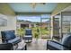 Relaxing screened porch with comfortable seating and a view of the landscaped backyard at 5116 Gato Del Sol Cir, Wesley Chapel, FL 33544
