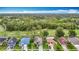 Aerial view of neighborhood homes with mature landscaping and solar panels at 5526 Braddock Dr, Zephyrhills, FL 33541