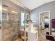 Modern bathroom featuring a large shower, soaking tub, and double sliding mirror door closet at 5526 Braddock Dr, Zephyrhills, FL 33541
