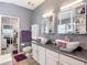 Elegant bathroom with double vessel sinks, granite countertops, and stylish lighting and a mirror-doored closet at 5526 Braddock Dr, Zephyrhills, FL 33541