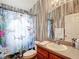 Eclectic bathroom featuring unique shark-themed shower curtain, vanity, and a large mirror at 5526 Braddock Dr, Zephyrhills, FL 33541