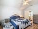 Bedroom featuring neutral paint, wood flooring, ceiling fan, and large windows for ample natural light at 5526 Braddock Dr, Zephyrhills, FL 33541