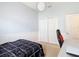 Bright bedroom with closet, a gaming chair, and unique modern orb light fixture at 5526 Braddock Dr, Zephyrhills, FL 33541