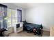 Cozy bedroom with a large window, laminate flooring and black-out curtains at 5526 Braddock Dr, Zephyrhills, FL 33541