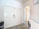 Front entryway features tile flooring and a double-door entry with arched doorway and view of interior at 5526 Braddock Dr, Zephyrhills, FL 33541