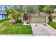 Charming single-Gathering home featuring a well-maintained lawn and mature palm trees accenting the property's curb appeal at 5526 Braddock Dr, Zephyrhills, FL 33541