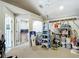 Spacious garage features an office nook and ample storage with shelving at 5526 Braddock Dr, Zephyrhills, FL 33541