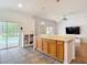 Open kitchen with granite counters, wooden cabinets, stainless appliances, and a view of the pool at 5526 Braddock Dr, Zephyrhills, FL 33541
