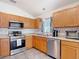Updated kitchen with stainless steel appliances and stylish subway tile backsplash offers a functional cooking space at 5526 Braddock Dr, Zephyrhills, FL 33541