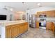 Modern kitchen showcases stainless steel appliances, granite countertops, and convenient access to dining at 5526 Braddock Dr, Zephyrhills, FL 33541