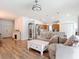 Open-concept living space adjoins the kitchen and features neutral decor and wood flooring throughout at 5526 Braddock Dr, Zephyrhills, FL 33541