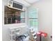 Bright home office features a white desk, a cat tree, and a unique Jeep-themed wall decoration at 5526 Braddock Dr, Zephyrhills, FL 33541