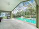 The screened-in pool area and the outdoor patio offers plenty of outdoor entertaining space at 5526 Braddock Dr, Zephyrhills, FL 33541
