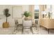 Open-concept dining area with stylish table, comfortable seating, and modern decor at 6849 E 115Th St, Palmetto, FL 34221