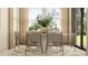 Contemporary dining room featuring a round table, modern chairs, and a decorative plant in the center at 6849 E 115Th St, Palmetto, FL 34221