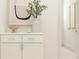 Hallway featuring decorative elements, white cabinets with modern hardware and neutral tones at 6849 E 115Th St, Palmetto, FL 34221