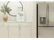 Contemporary kitchen with stainless steel refrigerator, white cabinets and decorative elements at 6849 E 115Th St, Palmetto, FL 34221
