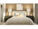 Bright main bedroom showcasing bedside tables and decorative lamps with light colored striped comforter at 6849 E 115Th St, Palmetto, FL 34221