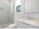 Bathroom featuring frameless glass shower and white vanity with white countertop at 804 S Davis Blvd, Tampa, FL 33606