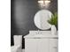 Modern powder room with a round mirror and gray textured wallpaper at 804 S Davis Blvd, Tampa, FL 33606