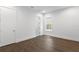 An empty bedroom featuring hardwood floors, white walls, and a bright window at 804 S Davis Blvd, Tampa, FL 33606
