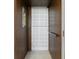 Residential elevator featuring wood paneling and a metal accordion gate at 804 S Davis Blvd, Tampa, FL 33606