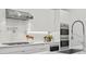 Close-up of a kitchen featuring high-end appliances, a stylish backsplash, and a modern faucet at 804 S Davis Blvd, Tampa, FL 33606