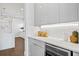 Modern kitchen featuring sleek white cabinets, under-cabinet lighting, and a wine cooler at 804 S Davis Blvd, Tampa, FL 33606