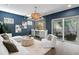 Bright living area featuring an indoor/outdoor bar, a modern seating area, and large windows at 804 S Davis Blvd, Tampa, FL 33606