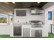 Outdoor kitchen with a grill and a TV for entertaining guests at 804 S Davis Blvd, Tampa, FL 33606