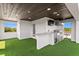 The rooftop has an outdoor kitchen with a TV and artificial turf for easy maintenance at 804 S Davis Blvd, Tampa, FL 33606