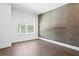 Minimalist room with textured wallpaper, a window providing natural light, and sleek hardwood floors at 804 S Davis Blvd, Tampa, FL 33606