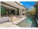 A luxurious outdoor space with a sparkling swimming pool, covered patio, and stylish design at 804 S Davis Blvd, Tampa, FL 33606