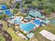 Aerial view of the community amenities including pools, tennis courts, recreational areas, and lush landscaping at 8202 Pinewood Run Ct, Tampa, FL 33647
