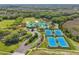 Gorgeous aerial view of the community amenities, including tennis courts and a pool at 8202 Pinewood Run Ct, Tampa, FL 33647