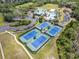 Overhead shot of the community tennis courts highlighting the pristine blue courts and surrounding greenery at 8202 Pinewood Run Ct, Tampa, FL 33647