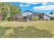 Spacious backyard showcasing a screened-in patio and lush green lawn, perfect for outdoor enjoyment at 8202 Pinewood Run Ct, Tampa, FL 33647