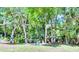 Beautiful backyard with mature trees and lots of places to sit and enjoy the scenery at 8202 Pinewood Run Ct, Tampa, FL 33647