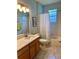 Bathroom featuring wooden vanity, tiled floors, and shower with tub at 8202 Pinewood Run Ct, Tampa, FL 33647