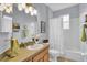 Bathroom featuring a vanity, commode, shower/tub combo and tiled flooring at 8202 Pinewood Run Ct, Tampa, FL 33647