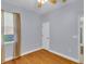 Neutral bedroom featuring light-colored walls, wood floors, and a window with curtains at 8202 Pinewood Run Ct, Tampa, FL 33647