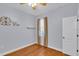 Neutral-painted bedroom with wood-look floors, curtained window and decor shelf at 8202 Pinewood Run Ct, Tampa, FL 33647