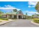 The Community Clubhouse with a covered walkway to the veranda with lush landscaping at 8202 Pinewood Run Ct, Tampa, FL 33647