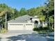 Charming single-story home featuring a spacious three-car garage and well-manicured landscaping at 8202 Pinewood Run Ct, Tampa, FL 33647