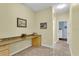 Hallway with built-in desk and cabinets, leading to a bedroom and bathroom at 8202 Pinewood Run Ct, Tampa, FL 33647